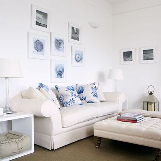 living room with white wall and sofa with cushions