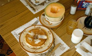 Pancakes with muskmelon on the table