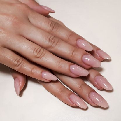 hands with a long neutral gel manicure