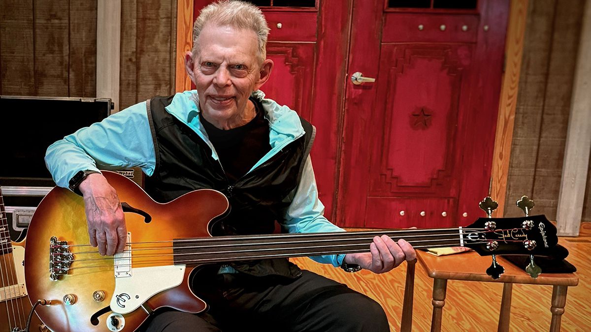 Jack Casady holds his new signature Epiphone Fretless Bass