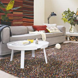 grey sofa, white coffee table and fluffy rug