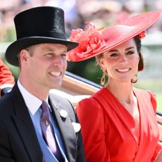 Prince William wears a top hat and tails and Kate Middleton wears a bright red dress and matching hat as they arrive at Royal Ascot 2023