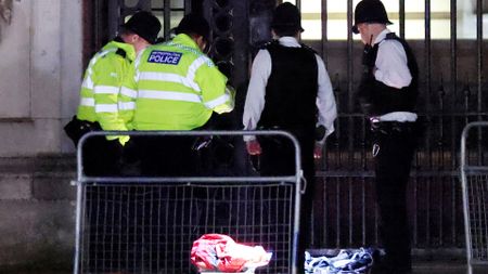 police officers outside buckingham palace burning object