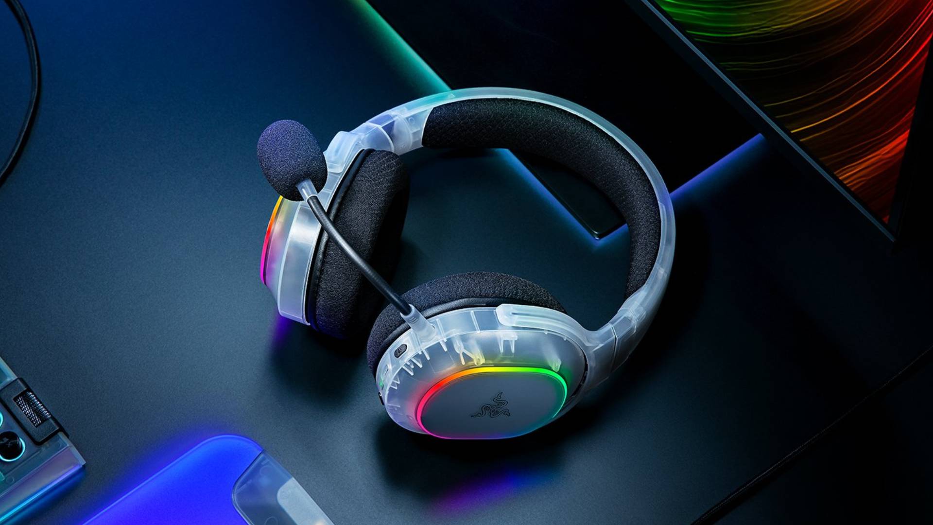 Promo image showing a translucent Razer headset sitting on a black desk.