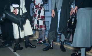 Female models wearing grey, cream, red and black clothes from the Thom Browne AW 2016 collection