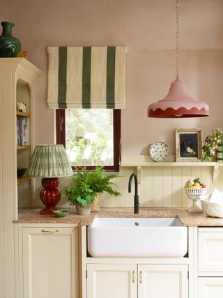traditional kitchen with colorful stripe blind and scallop edge pendant light