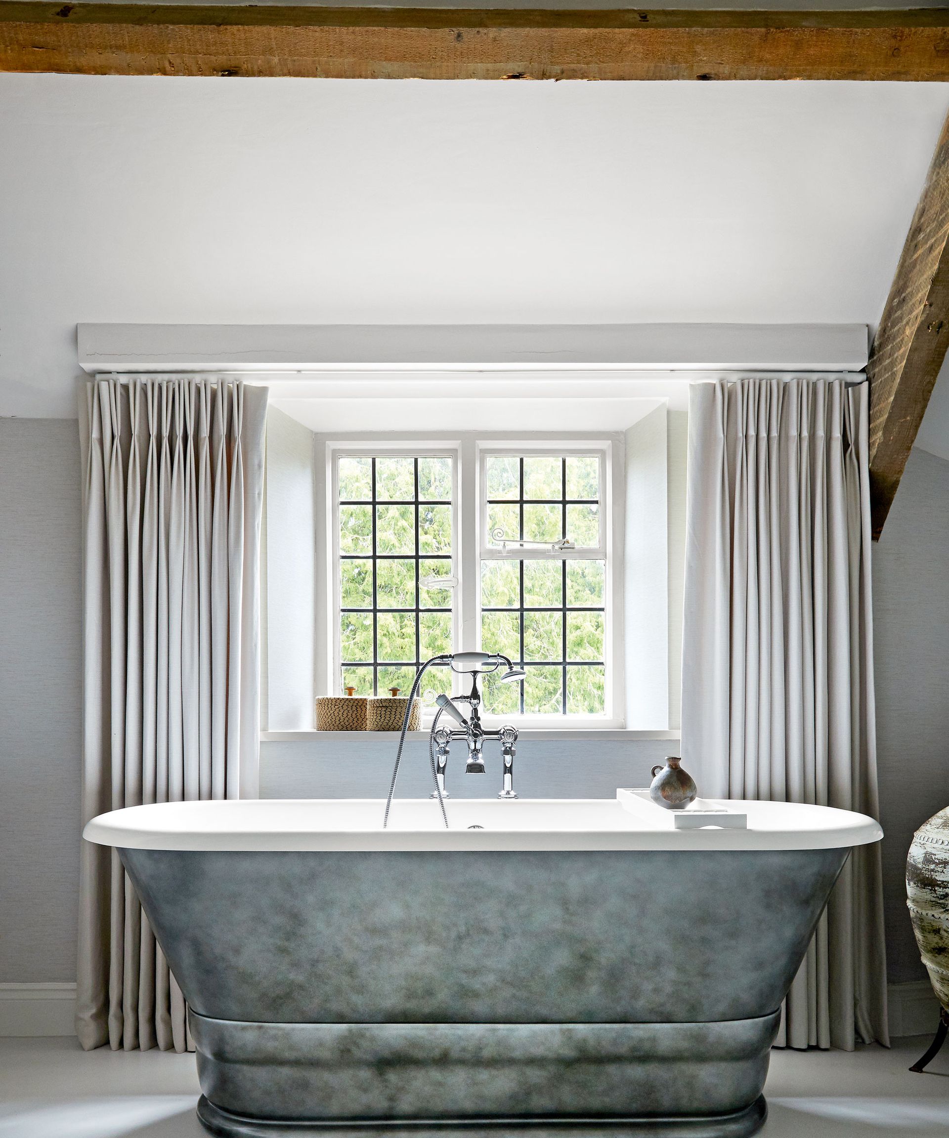 bathroom with tub and large window