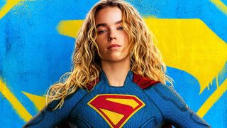 Supergirl in costume in front of blue and yellow symbol in Supergirl poster