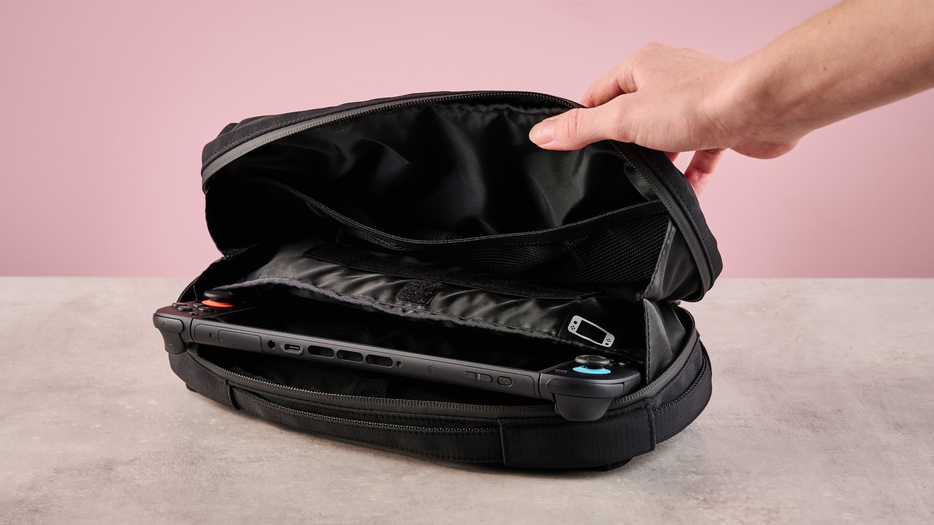 Person opening up the Hori Puff Pouch for Nintendo Switch 2