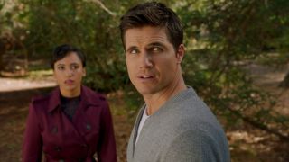 Andy Allo and Robbie Amell looking towards the sky in Upload.