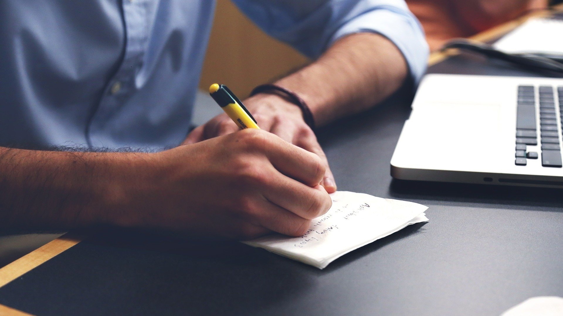 Man noting down information he has found online