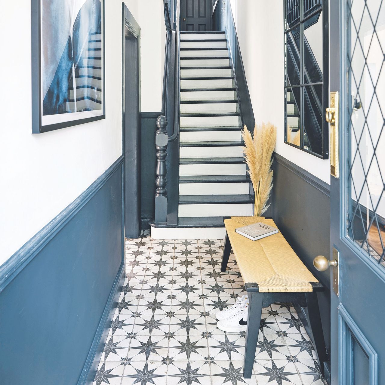 White painted hallway with blue panelling and star patterned floor tiles