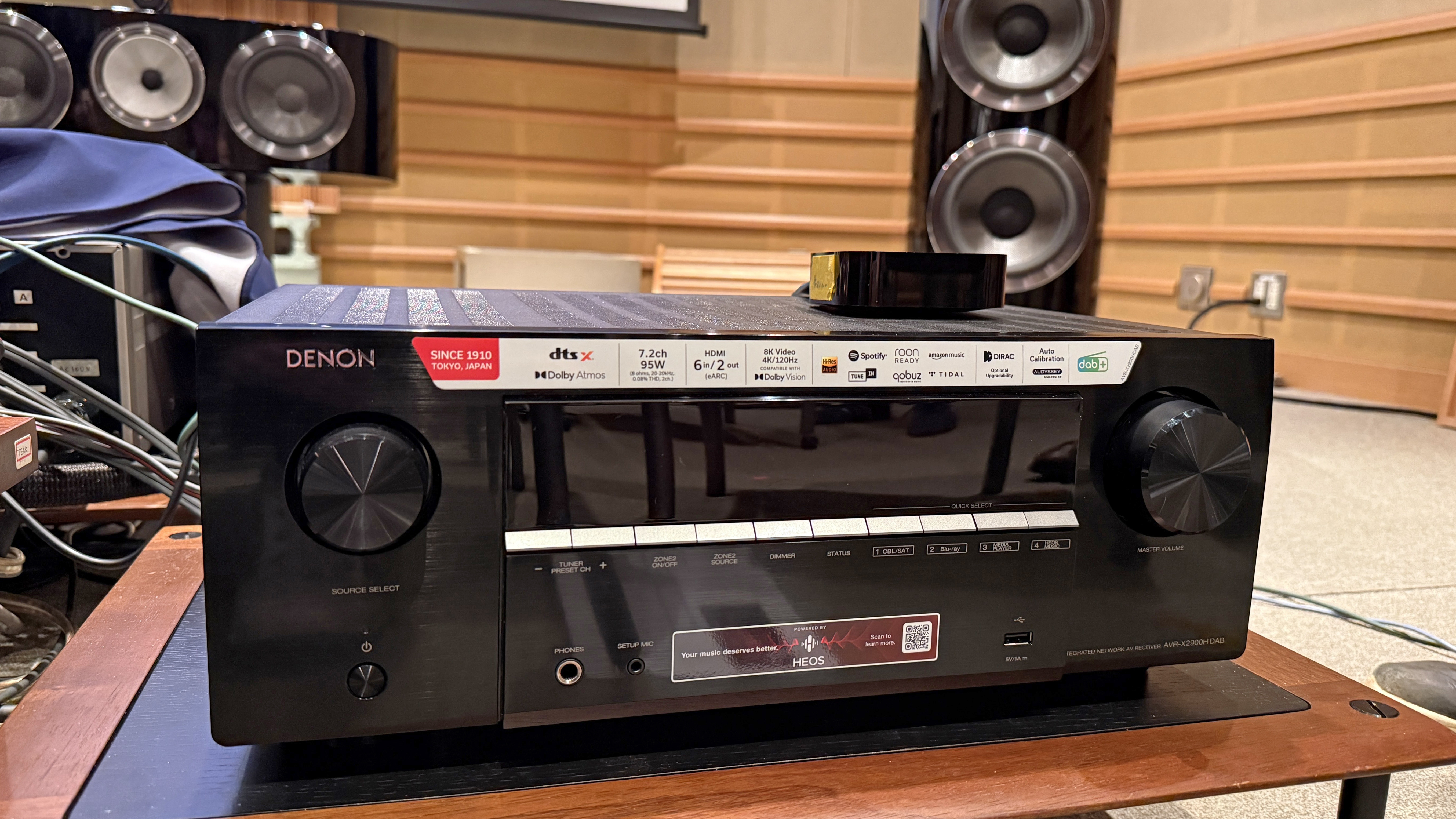 The Denon AVR-X2900H with Bowers &amp;amp; Wilkins speaker just visible behind it. It's a black box with some dials and buttons on the front.