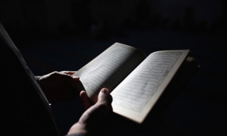 A Muslim man reads the Koran, the religious text of Islam.