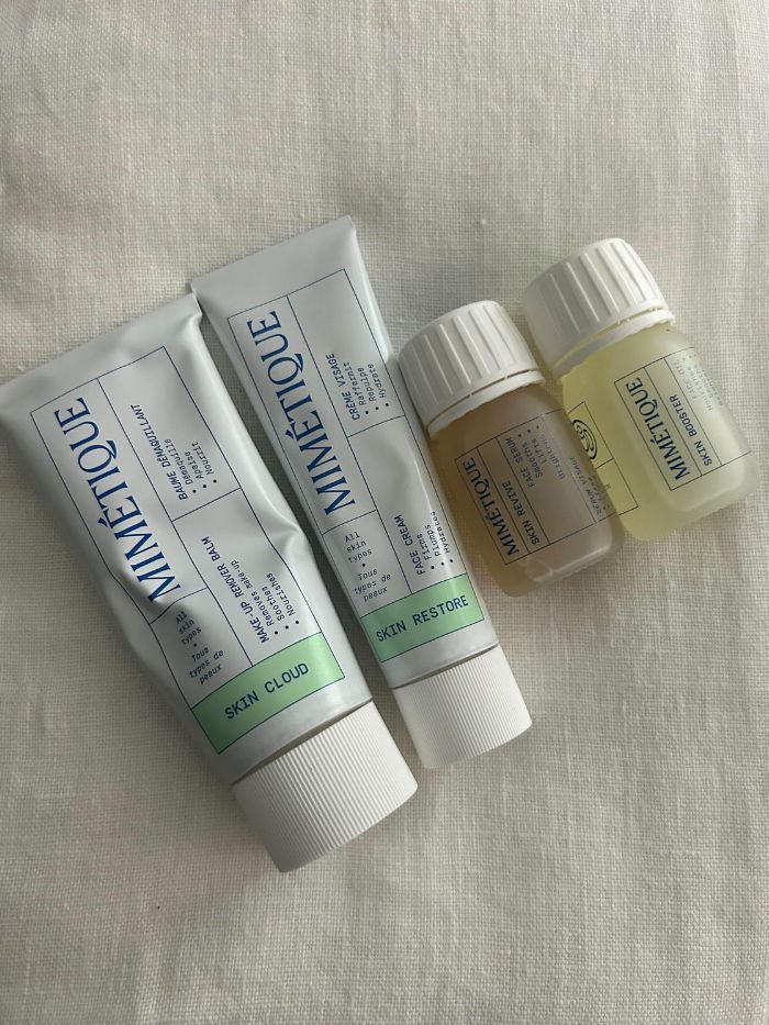 All four Mimetique skincare products on a white linen background