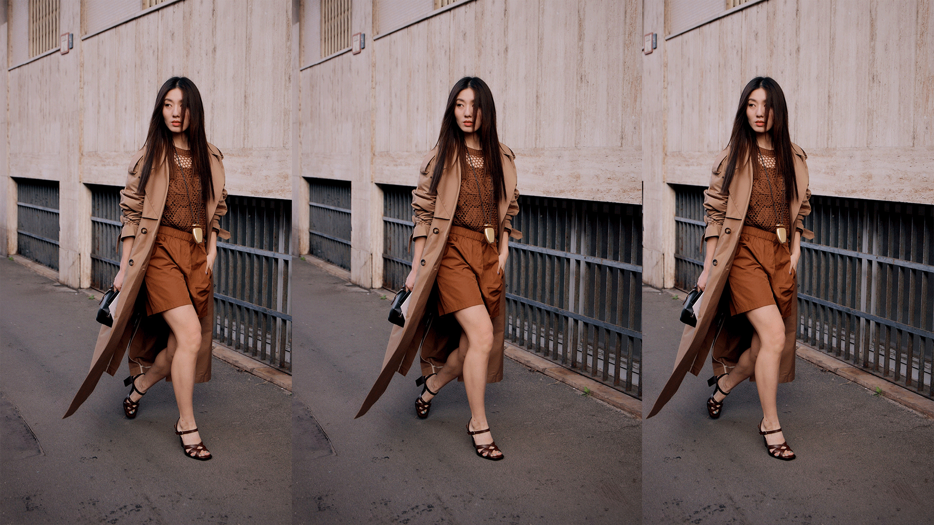 Woman wears toffee brown top and shorts with a tan trench coat while posing and walking for the camera