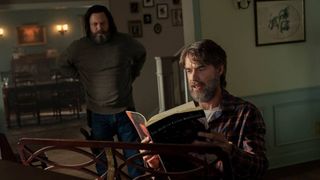 Frank (Murray Bartlett) sits at Bill's (Nick Offerman) piano reading a songbook in The Last Of Us episode 3