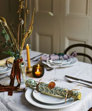 Christmas table decorated with candles and crackers