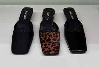 Three pairs of Prada square-toe mules in black satin, black patent leather, and leopard print calf hair.