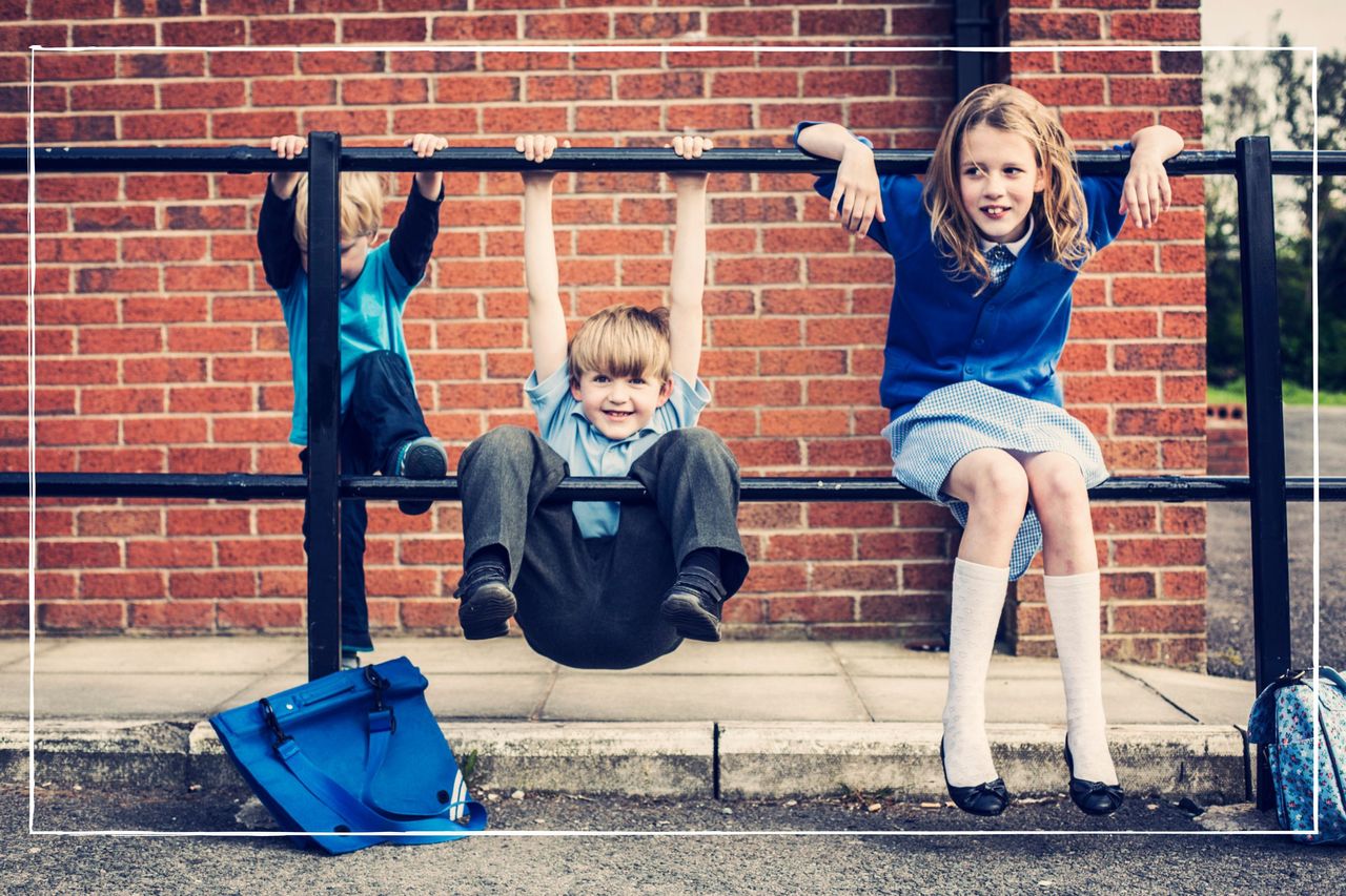 school kids of different ages playing on railing at school