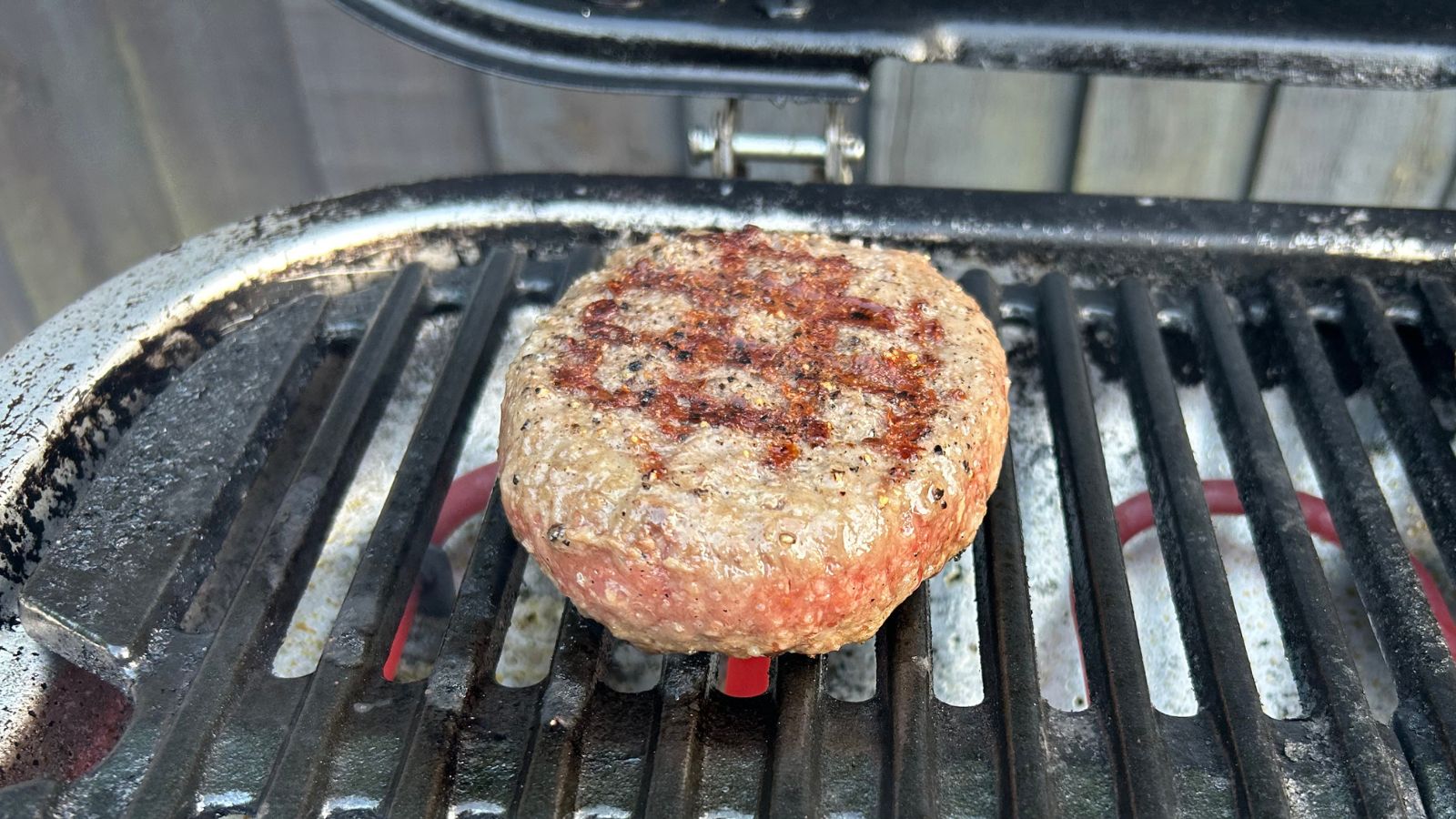 Cooking burgers on an electric grill with defined grill lines on one side