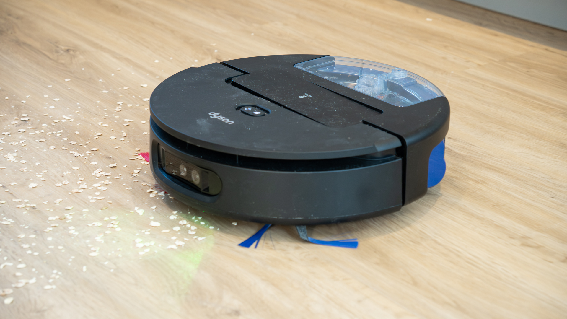 Dyson Spot+Scrub Ai robot vacuum sweeping up oats