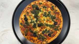 A garlic, spinach, and black olive fiorentina pizza cooked in the Breville the Smart Oven Air Fryer Toaster Oven