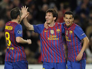 Lionel Messi celebrates with Andres Iniesta and Pedro after scoring for Barcelona against Bayer Leverkusen in the Champions League in March 2012.