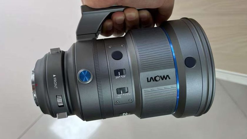 A hand holding the Laowa AF 200mm f/2.0