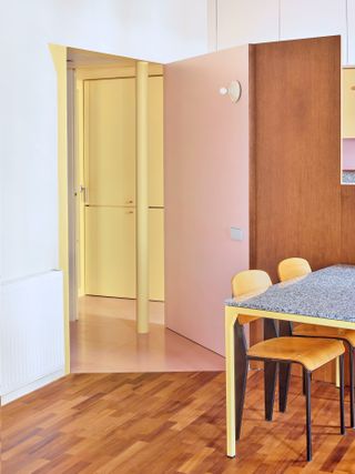 A space with peach doors and yellow walls