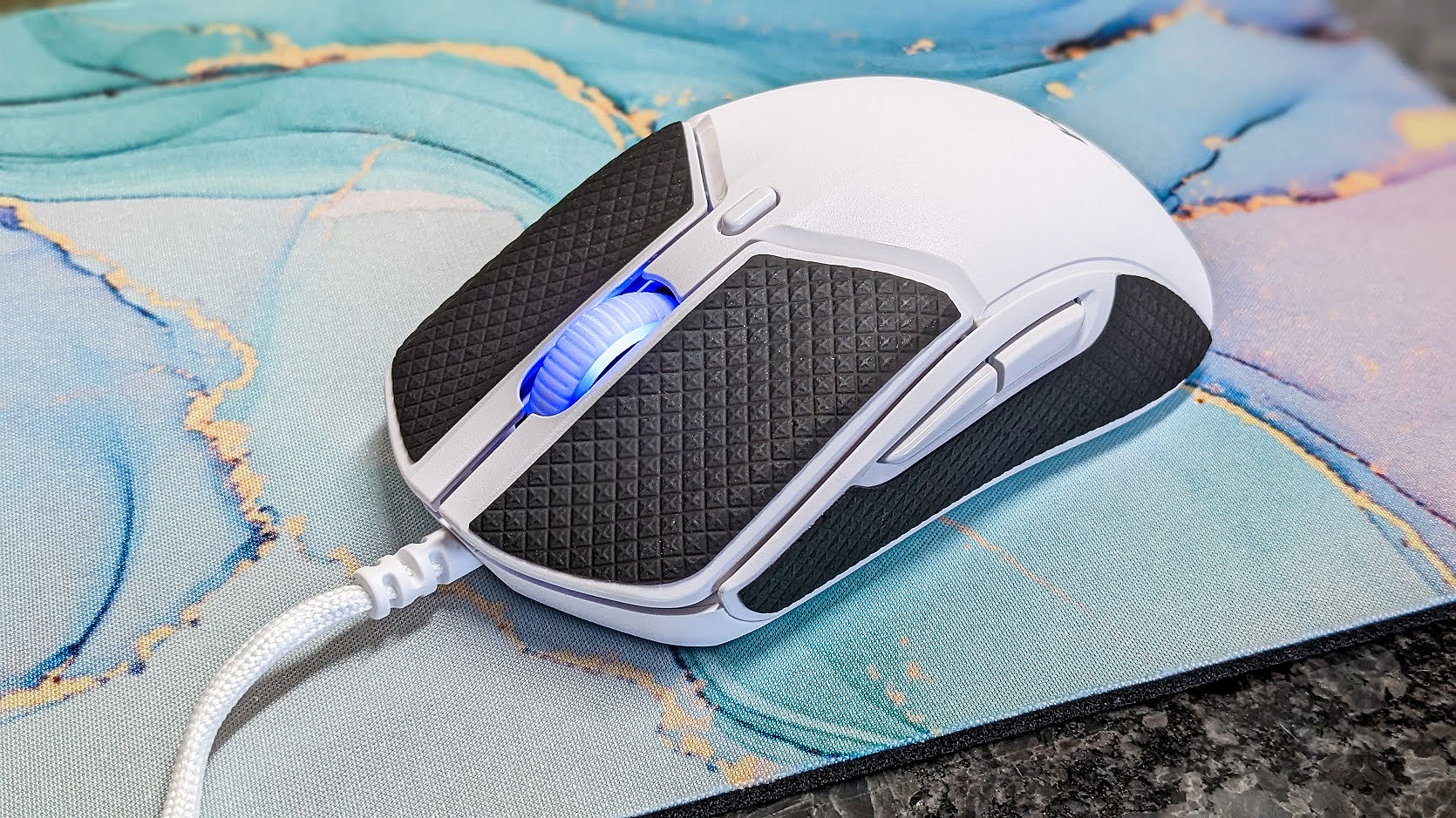 HyperX Pulsefire Haste 2 gaming mouse with grip adhesives