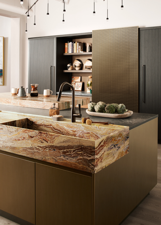 Modern brass kitchen with a large marble sink in the kitchen island