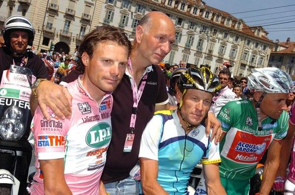Photographer Roberto Bettini with Danilo Di Luca and Lance Armstrong during a pre-stage ceremony to honor the memory of Bettini's moto pilot Fabio Saccani.