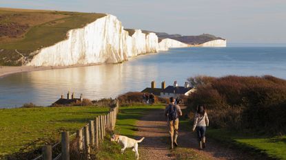 Dog walkers on the Seven Sisters Cliffs, perfect UK lockdown stroll