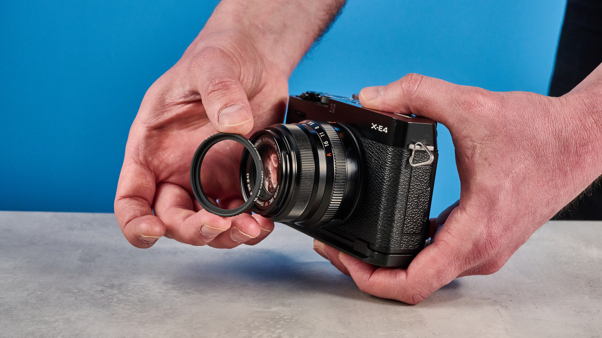 A photo of a Neewer Mist Filter being fitted to a Fujifilm X-E4