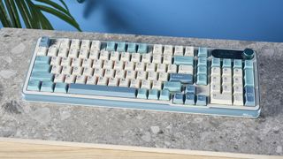 A Royal Kludge S98 wireless mechanical keyboard with blue, teal and white double-shot ABS keycaps