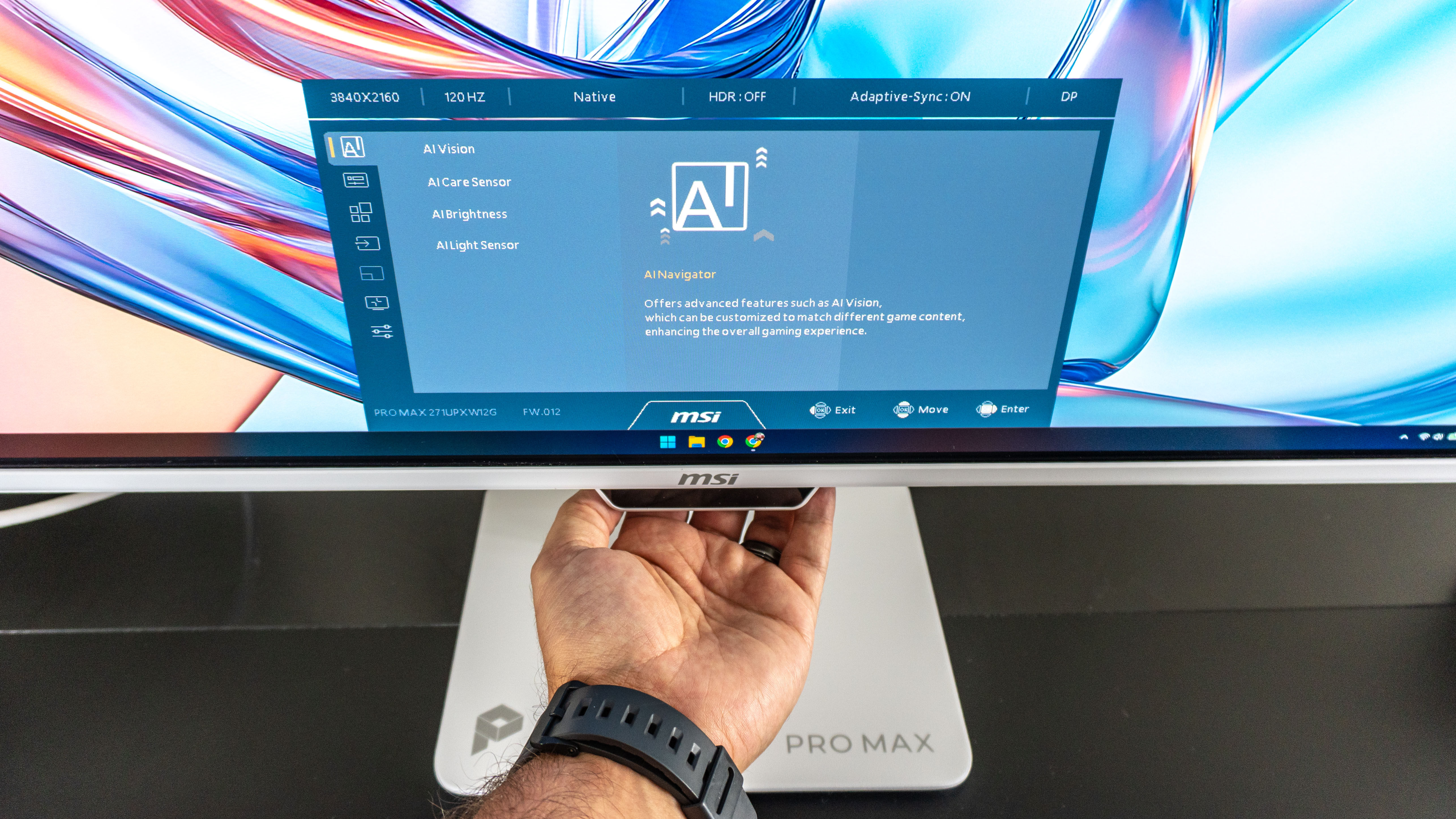 A person adjusting settings on the MSI Pro Max 271UPXW12G monitor using its joystick to navigate the OSD menu