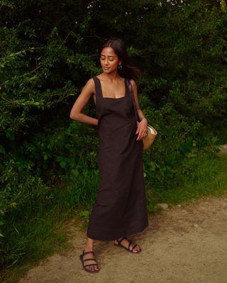 Trishna wearing brown dress