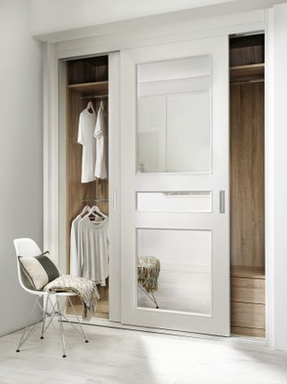 clothes organization ideas with neutral pale white wardrobe by Neatsmith
