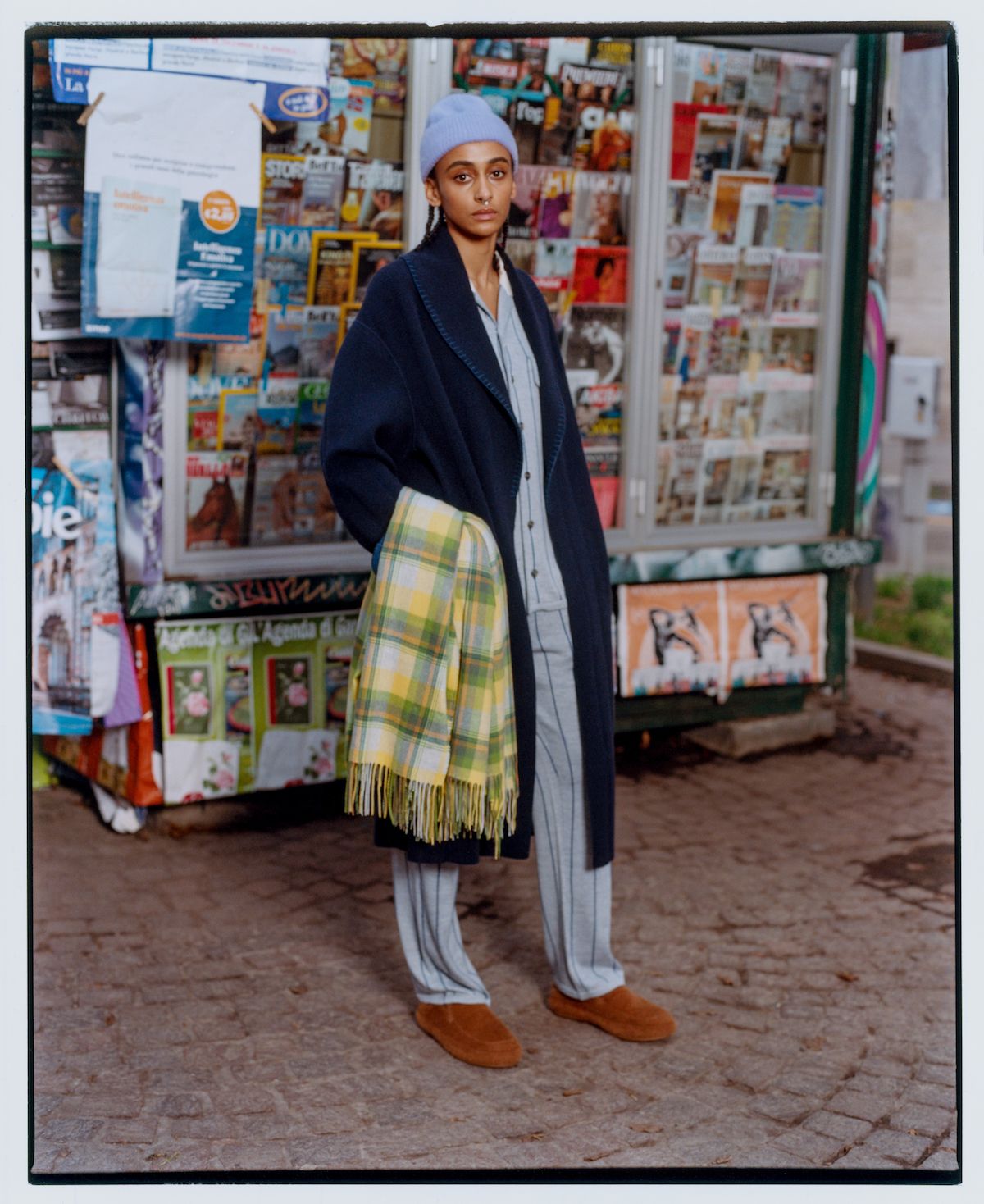 Woman in Zegna x The Elder Statesman colourful cashmere by market stall
