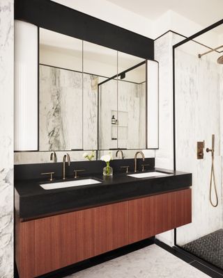 white bathroom with walnut millwork and brass taps