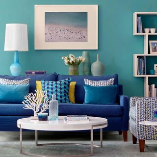 living room with sea blue walls and picture frame on the wall