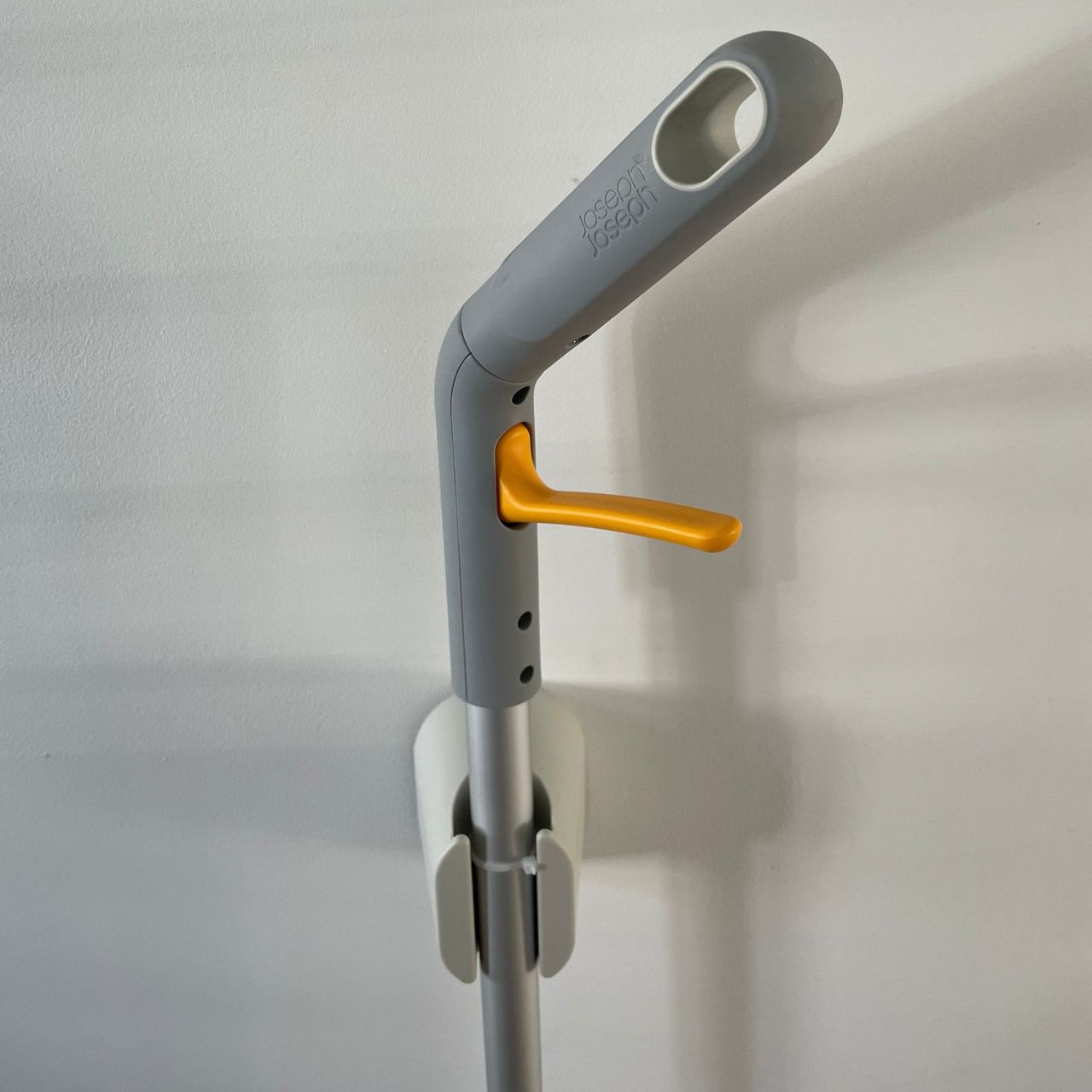 Joseph Joseph CleanTech 2-in-1 Spray Mop in its wall mounted holder