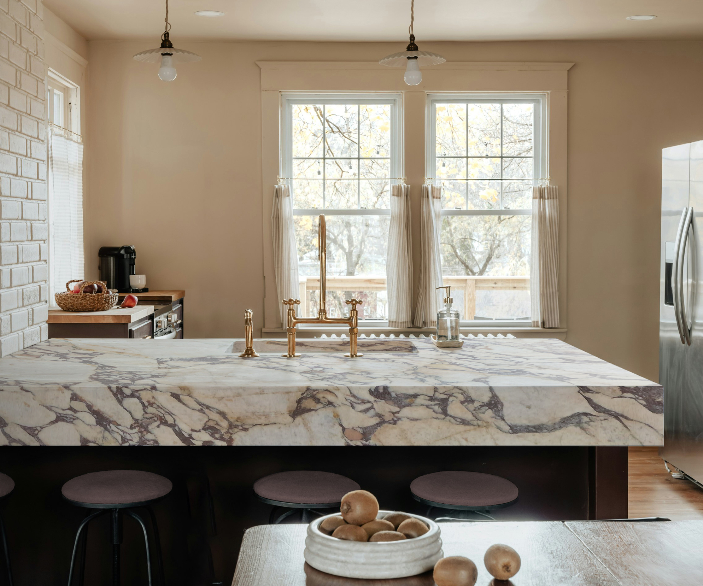 veined thick marble kitchen island worktop with inbuilt sink and dark wooden base