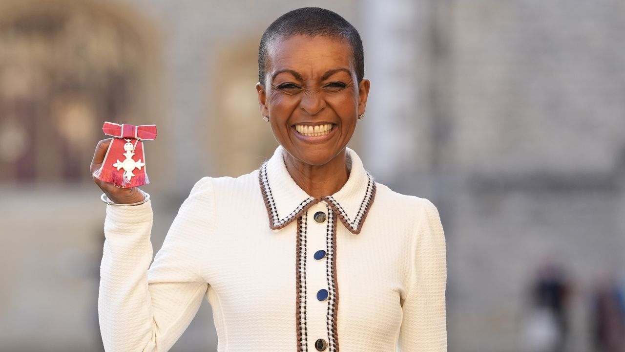 Adjoa Andoh holds up her MBE award after being made a Member of the Order of the British Empire (MBE) at Windsor Castle on December 10, 2025