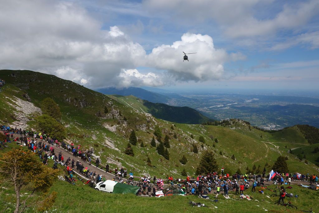 The pack rides in the ascent of Monte Grappa during the 20th stage of the 107th Giro d'Italia cycling race, 184km between Alpago and Bassano del Grappa on May 25, 2024. (Photo by Luca Bettini / AFP)