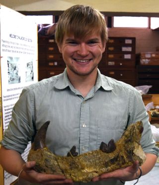 Matt Borths holds the ancient Simbakubwa kutokaafrika jaw.