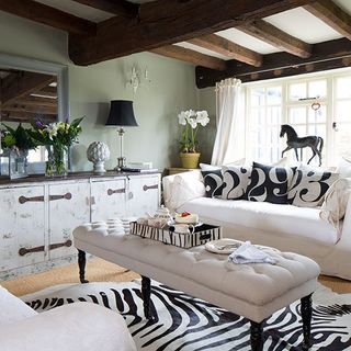 room with zebra rug white sofa and black lamp
