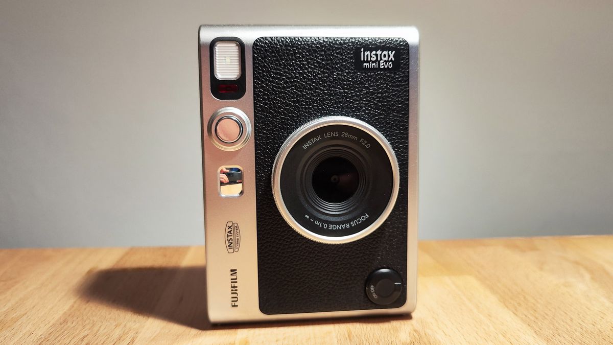 The Fujifilm Instax Mini Evo on a wooden table