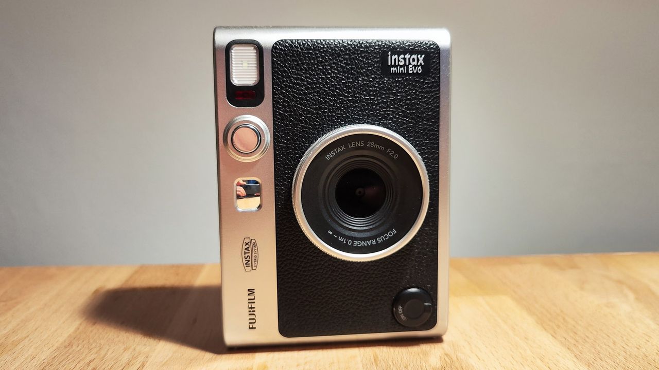 The Fujifilm Instax Mini Evo on a wooden table